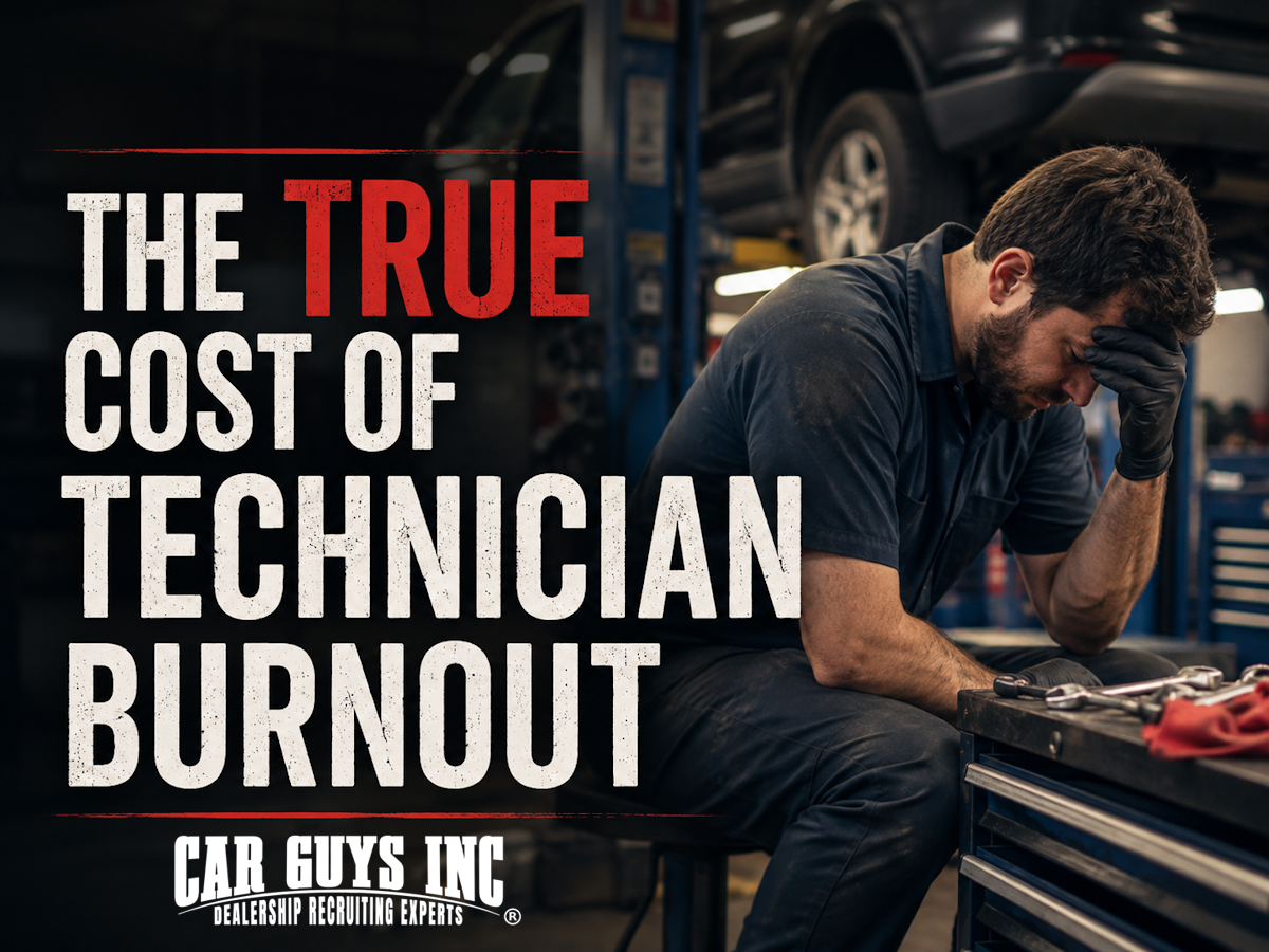 Exhausted automotive technician leaning against a service bay lift during a long shift