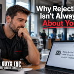 A dealership employee looking at a rejection notice on his computer.
