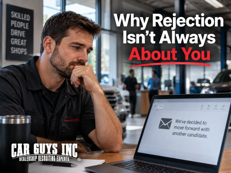 A dealership employee looking at a rejection notice on his computer.